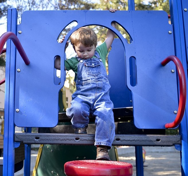 child on play equipment