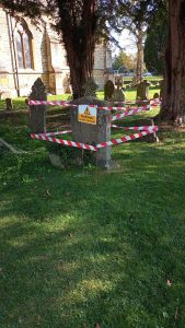 A picture of a memorial with tape and signage to indicate that it has failed the stability test