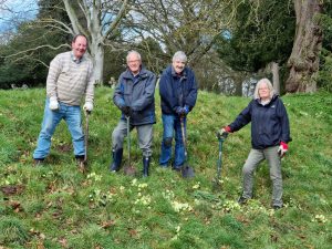 Gardeners with spades on grass