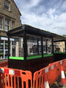 A bus shelter and roadworks barriers