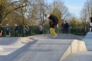 Youth flipping skateboard on a ramp