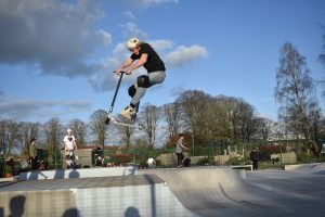 Youth jumping with scooter 