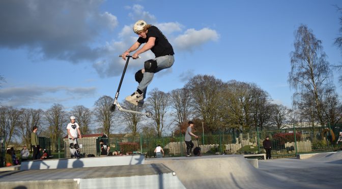 Youth jumping with scooter