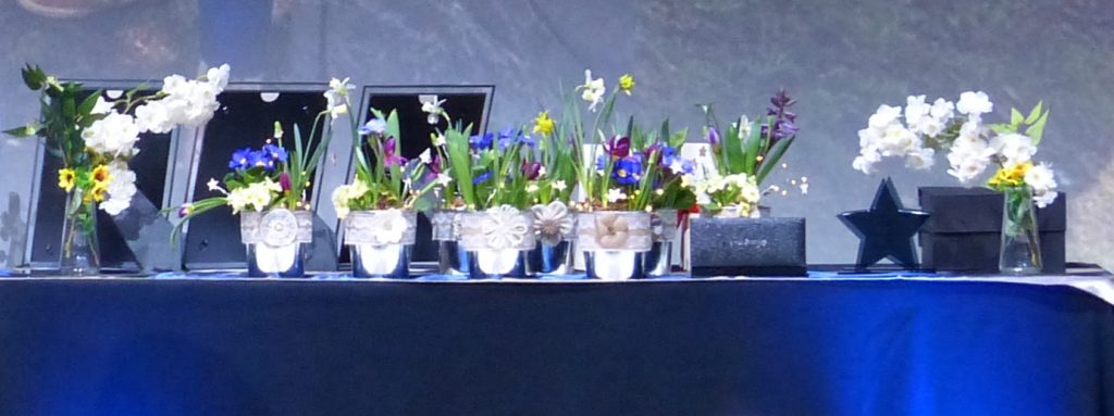 A table with flowers and trophies